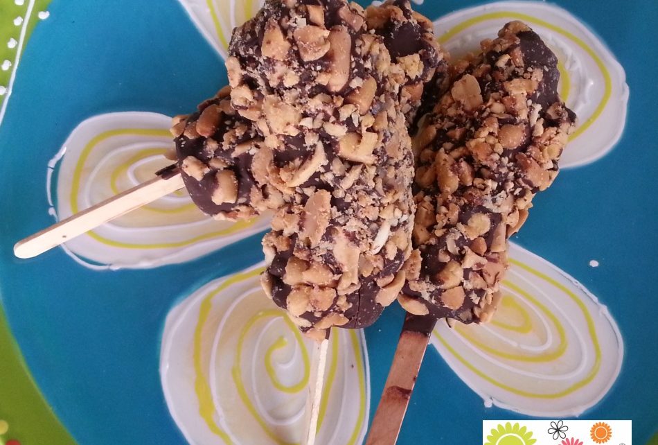 Frozen bananas dipped in chocolate and peanuts