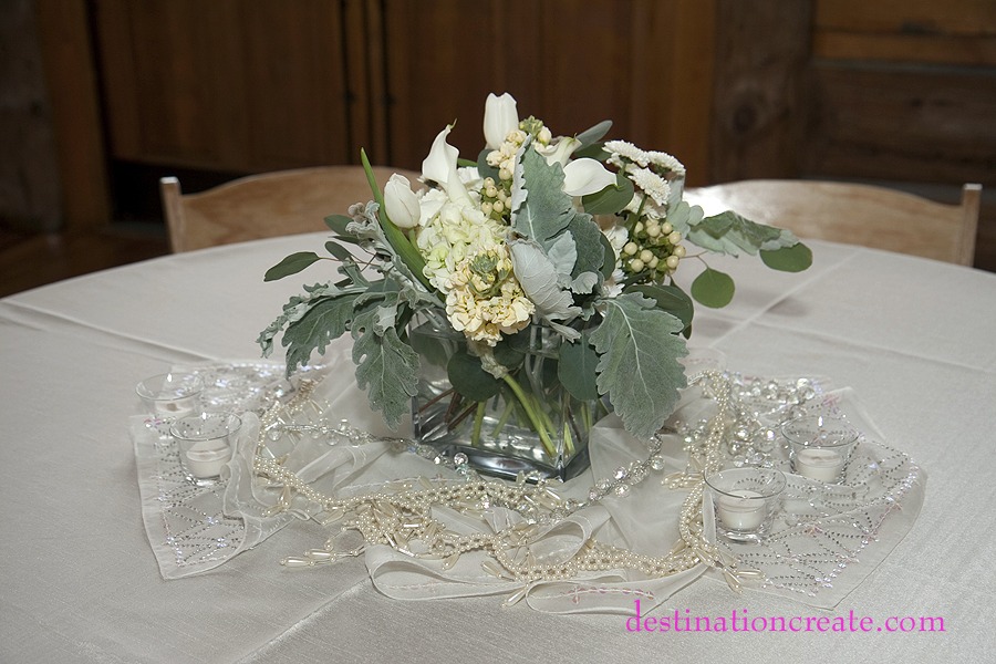 White wedding centerpiece- Evergreen Lake House: Destination Create offers full to partial wedding planning, decorating, styling, planning & specialty rentals.