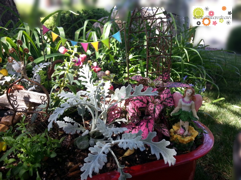 Fairy garden in little red wagon with Gypsy Garden by Genevieve Gail