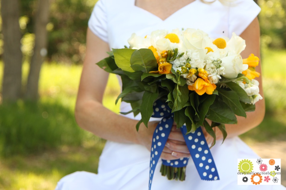 Yellow and blue wedding bouquet-white roses, carnations and stock with yellow billy balls and freesia.