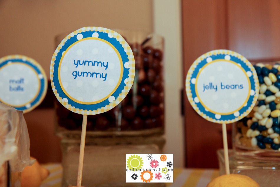 Yellow and blue wedding candy buffet with DIY signs anchored in lemons.