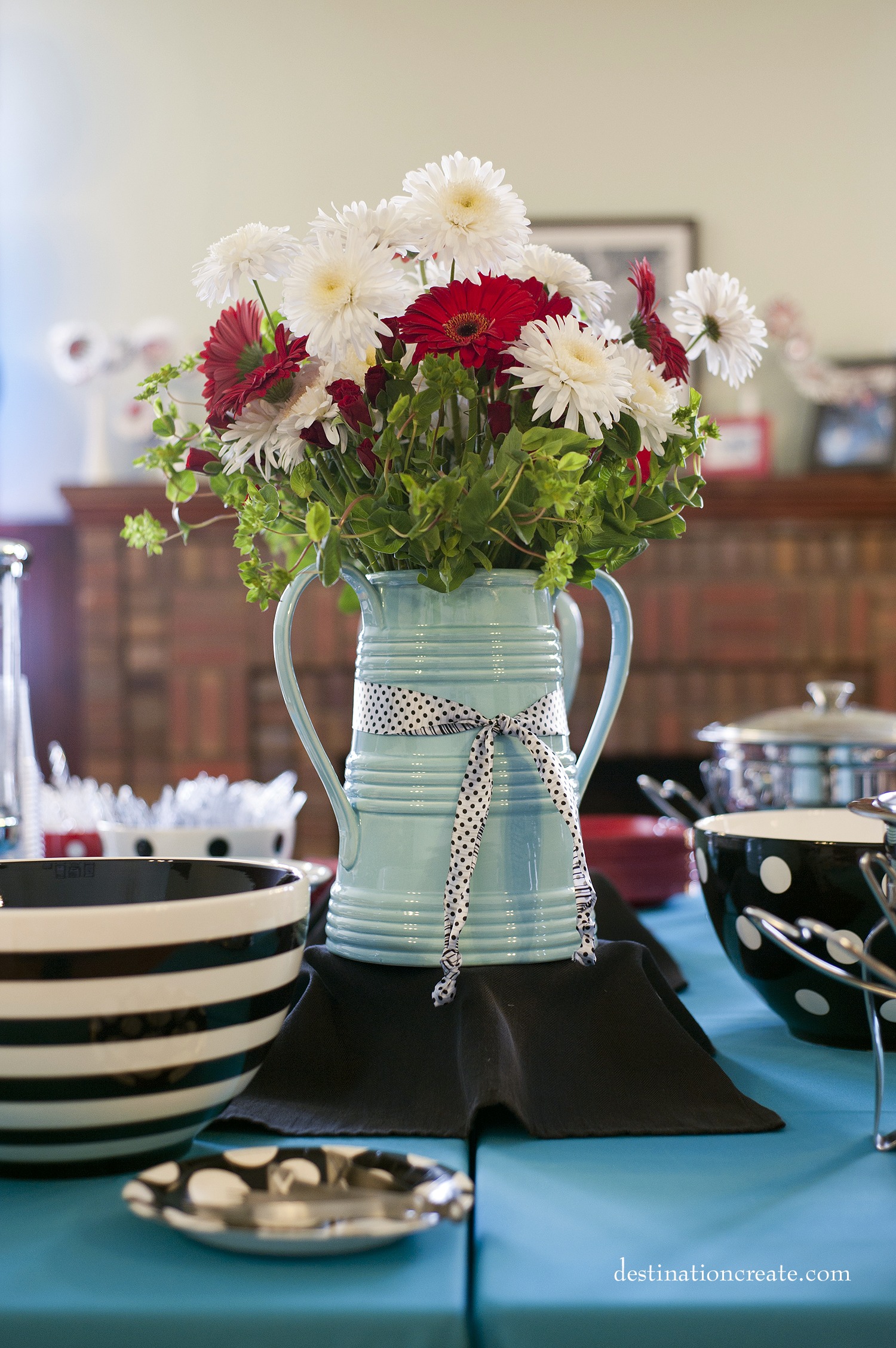 Red and white wedding flowers in turquoise farm vase