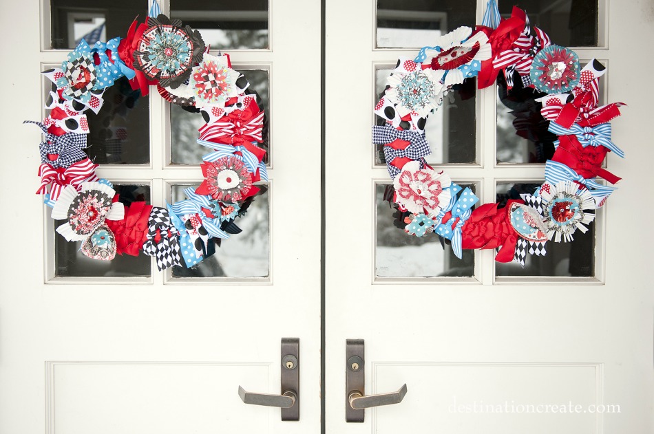 Handcrafted cupcake liner flower wreaths grace the wedding entrance.