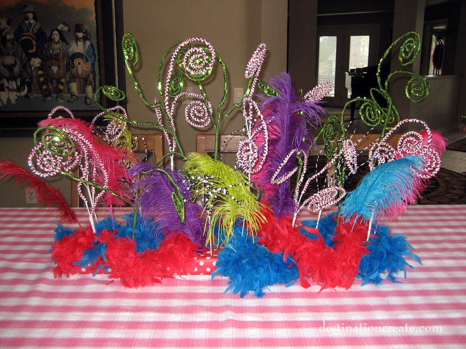 Feathers and Christmas stems create a whimsical Dr. Seuss centerpiece.