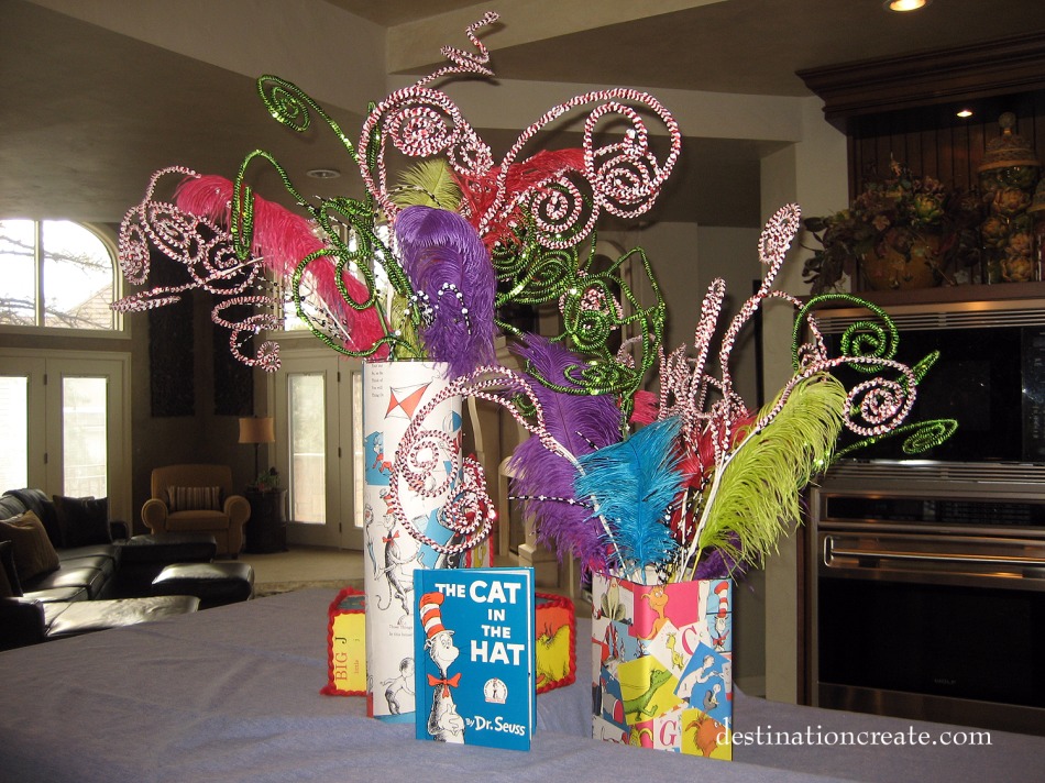Dr Seuss centerpiece made by covering glass vases with thrift store book pages.