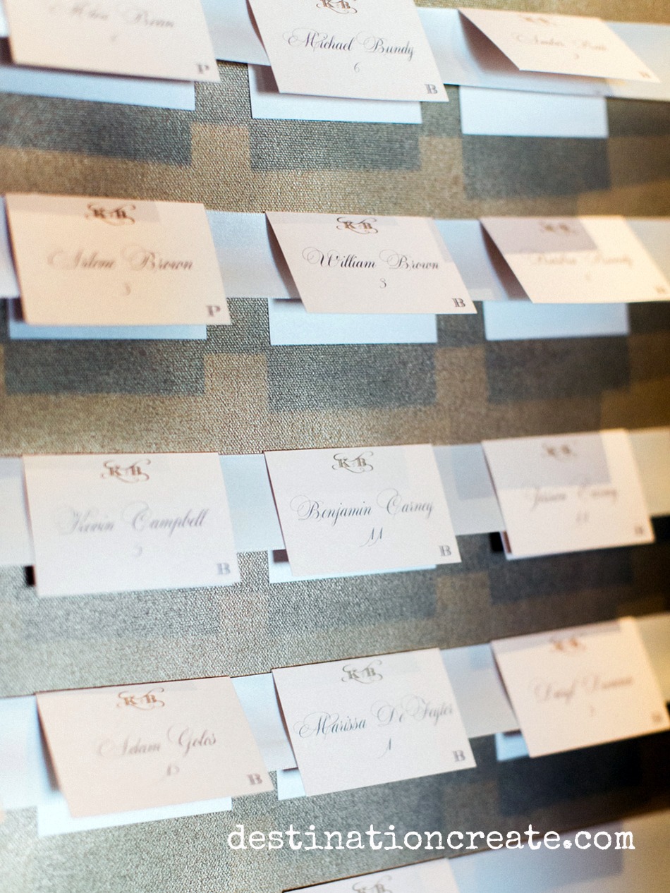 Escort cards were displayed on gold spray painted stretched canvas installed in gold frames
