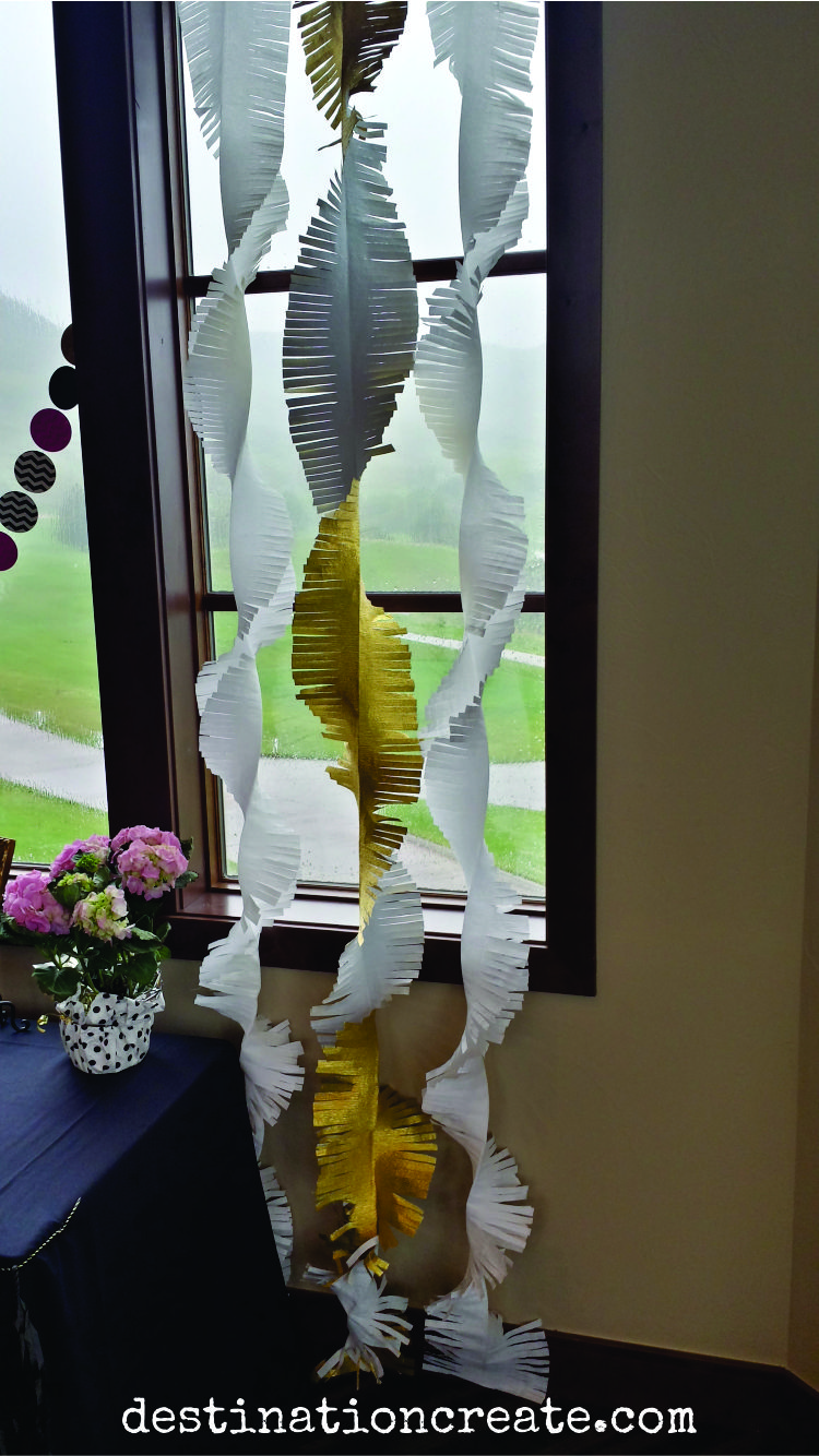 Fabulous giant fringed crepe paper garlands deck the windows at this college grad party